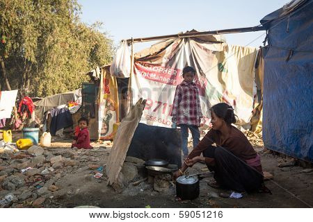 KATHMANDU, NEPAL - DEC 16: Unidentified poor people near their houses at slums in Tripureshwor district, Dec 16, 2013 in Kathmandu, Nepal. Caste of untouchables in Nepal, is about 7 % of population.