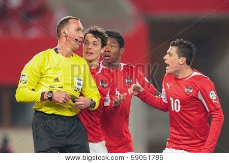 VIENNA,  AUSTRIA - MARCH 22 Philipp Hosiner (#20 Austria) discusses with Referee Oleksandr Berdo (Ukraine) during the world cup qualifier game on March 22, 2013 in Vienna, Austria.