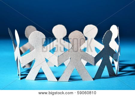 Team of paper people in chain