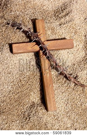 Wooden Cross And Thorns On Sand Background