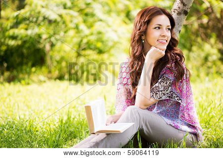 Girl with a book in the park