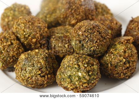 A plate of homemade falafal Egyptian-style chickpea, parsley and coriander spicy balls on a plate after being fried.