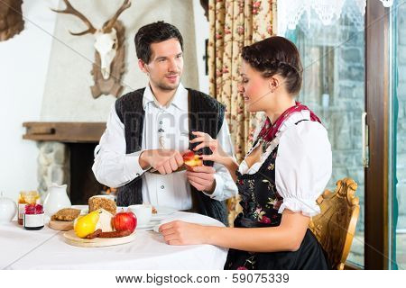Couple in a traditional mountain hut having a meal