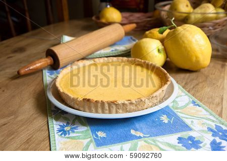Lemon tart with lemons and rolling pin