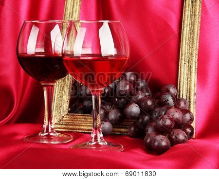 composition of frame,wine and grapes on bright background