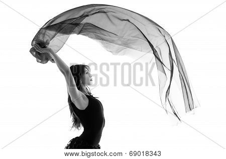 Young beautiful ballerina dancing with a flying veil