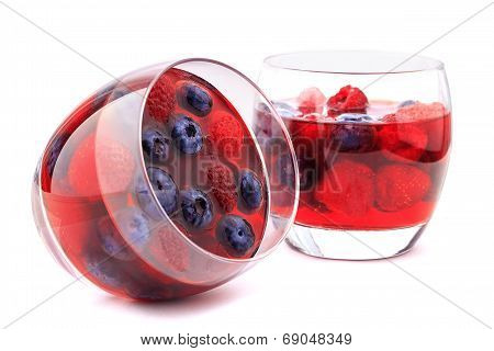 Blueberry and raspberry in glasses isolated on white