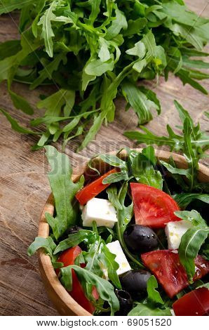 Greek Salad In A Wooden Salad Bowl On The Table