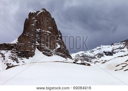Snowy Rocks And Grey Sky
