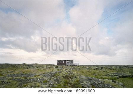 Shack in rugged landscape