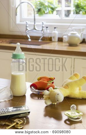 Closeup of baby Items on kitchen counter by cellphone and keys