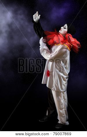 Beautiful Pierrot clown singing in the night