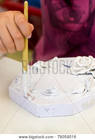 Asian Girl's Hand Painting The White Color To The Piece Of Papermache For The First Step.