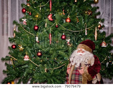 Santa Doll Under Christmas Tree