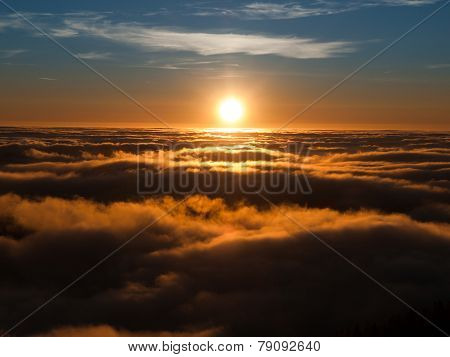 Sunset above clouds