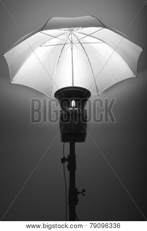 Detail of studio flash strobe light and umbrella on stand strobist professional photographer