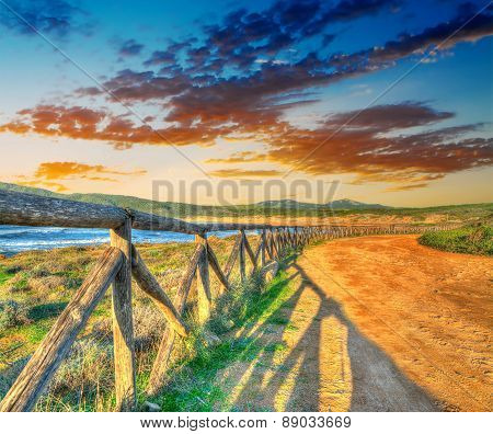 Colorful Sunset By Porto Ferro Shoreline
