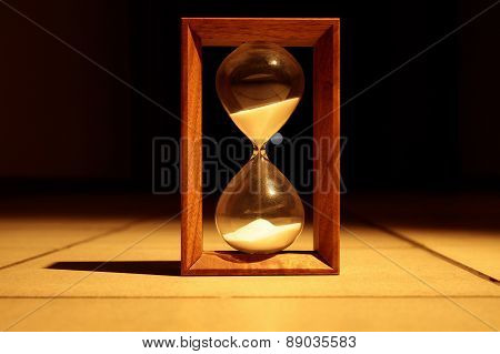 Sandglass in dark corridor
