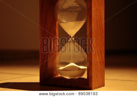 Sandglass in dark corridor