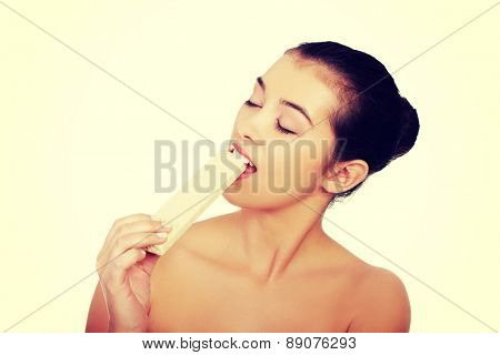 Beautiful woman eating a waffer