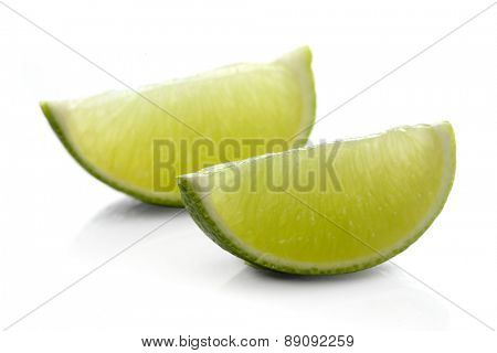 Limes on white background - close-up