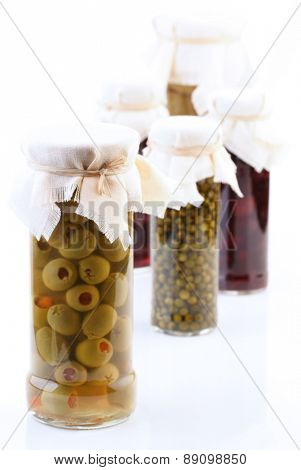 Pickled vegetbles in jars on white background