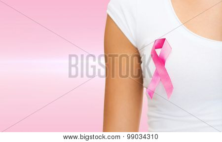 healthcare and medicine concept - woman in blank t-shirt with pink breast cancer awareness ribbon