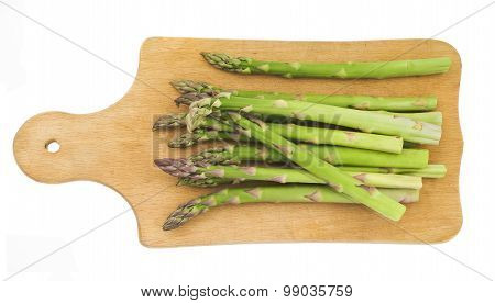 Bunch of fresh green asparagus on a wooden cutting board