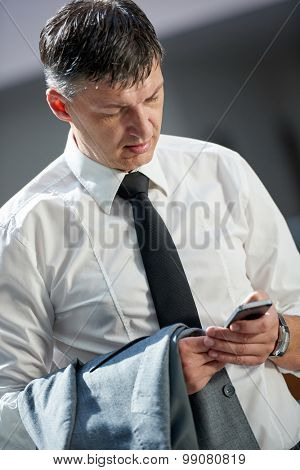 business man using phone at modern office space