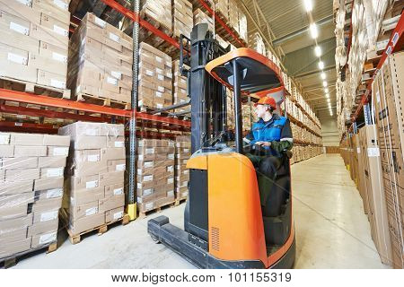 warehouse forklift stacker loader stacking cardboxes in storehouse 