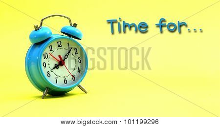 Picture of blue alarm clock on a yellow background