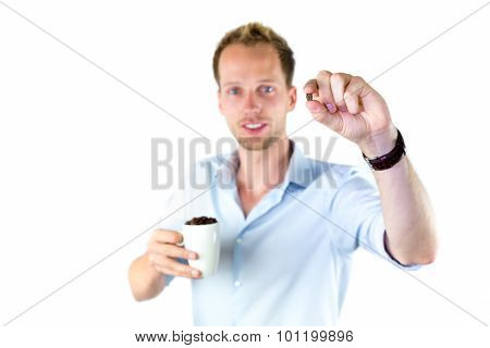 Young Salesman Holding Cup And Coffee Beans