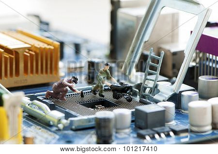 Miniature Workers Repairing A Processor