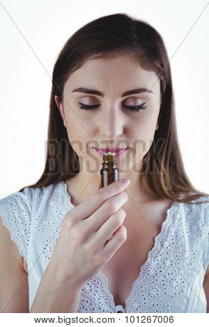 Pretty woman taking alternative tincture on white background