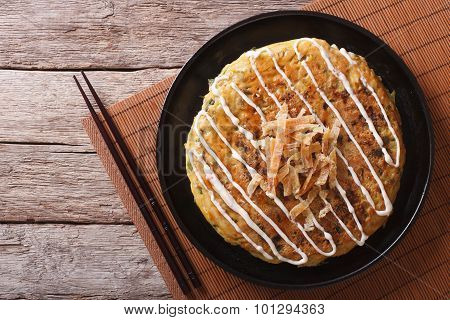Japanese Okonomiyaki On A Wooden Table. Horizontal Top View