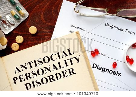 antisocial personality disorder written on book with tablets.