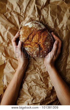 Hands Holdig Bread On The Craft paper