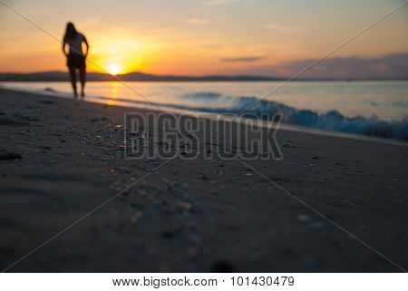 Dawn of the sand and the silhouette of the girl