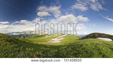 panorama of summer snow mountains with big grass valley