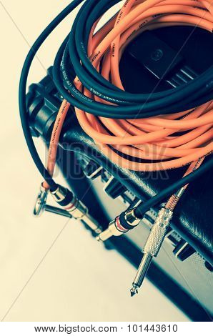 Close-up of guitar amplifier with jack cable.