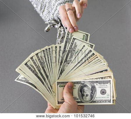 Picking cash note of the hands of husband