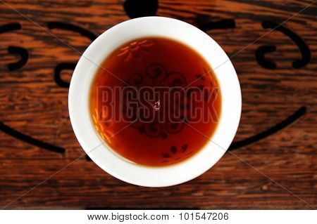 Chinese Black Puerh Tea In White Bowl On Wooden Tea Tray