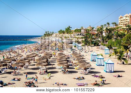 People Sunbathing In The Picturesque El Duque Beach