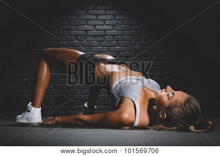 Woman exercising l workout posture in fitness club
