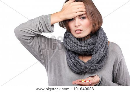 ill woman taking her temperature wile feeling sick and with fever, isolated on a white background
