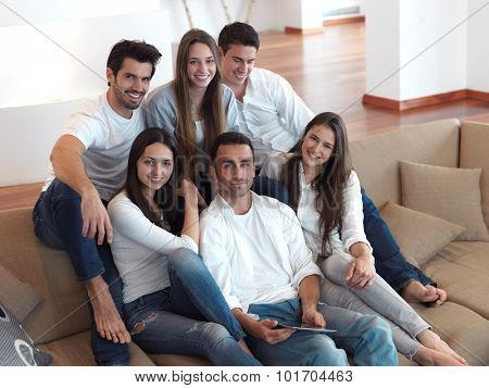 group of friends taking selfie photo with tablet at modern home indoors