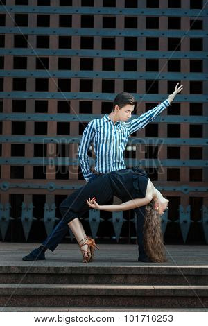 Girl Bent In The Dance, Guy Supports It.