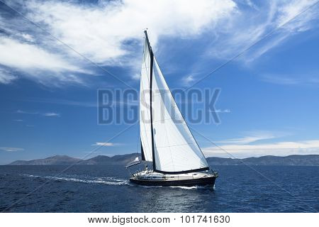 Sailing ship yachts with white sails in the Sea. Luxury boats.