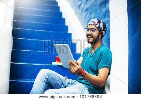 Sikh Guy Browsing Tablet Stair Case Concept