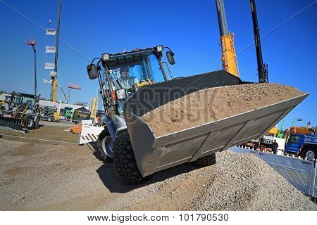 Man Works With Kramer Allrad 350 Wheel Loader